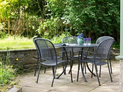 a black table with four chairs and a vase on it at 3 Bed in Keswick oc-sz142 in Portinscale