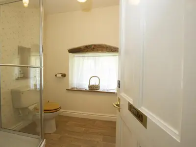 a bathroom with a toilet and a glass door at 3 Bed in Newlands Valley SZ075 in Borrowdale Valley