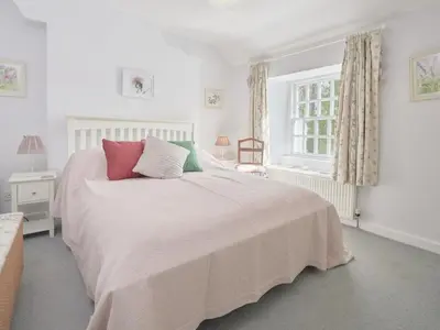 a white bedroom with a large bed and a window at 4 Bed in Keswick oc-sz434 in Applethwaite