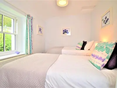 two beds in a white room with a window at 4 Bed in Keswick oc-sz434 in Applethwaite