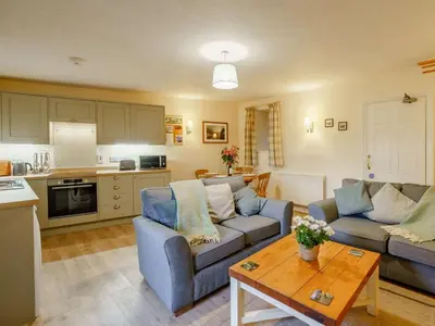 a living room with a couch and a table at 2 Bed in Penrith oc-sz339 in Watermillock