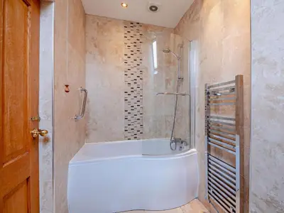 a bathroom with a white tub and a shower at 3 Bed in Keswick oc-sz135 in Threlkeld