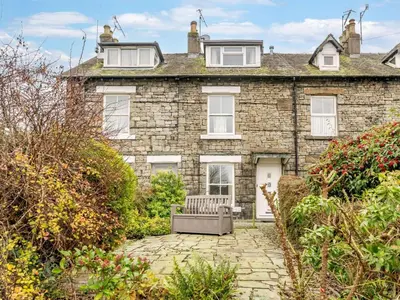 a stone house with a bench in front of it at 2 Bed in Keswick oc-sz036 in Keswick