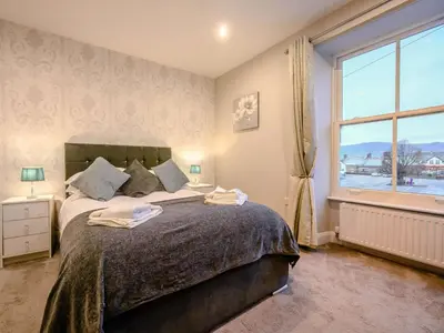 a bedroom with a large bed with a large window at 2 Bed in Keswick oc-sz036 in Keswick