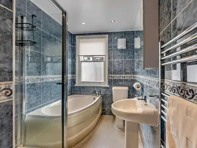 a bathroom with a tub and a sink at 2 Bed in Keswick oc-sz026 in Keswick