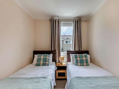 two beds in a room with a window at 2 Bed in Keswick oc-sz026 in Keswick