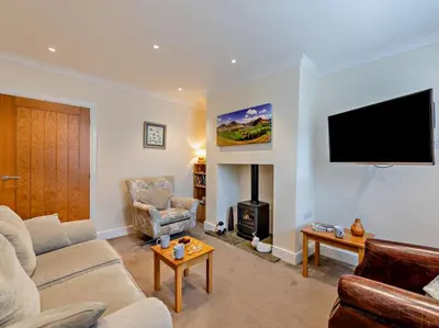 a living room with a couch and a tv on the wall at 2 Bed in Keswick oc-sz026 in Keswick