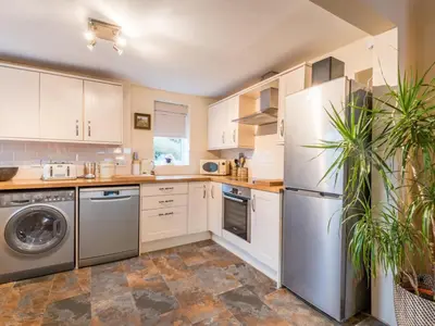 a kitchen with white cabinets and stainless steel appliances at 3 Bed in Gosforth oc-sz064 in Gosforth