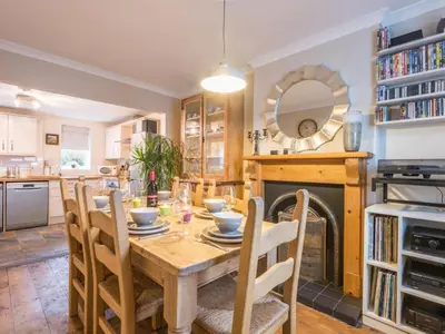 a dining room with a table and a fireplace at 3 Bed in Gosforth oc-sz064 in Gosforth