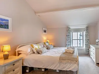 a bedroom with a bed and a dresser and a window at 1 Bed in Keswick oc-sz112 in Keswick