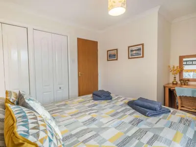 a bedroom with a bed with blue pillows on it at 2 Bed in Keswick SZ462 in Keswick