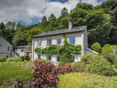 a white house with ivy growing on it at 3 Bed in Applethwaite SZ540 in Applethwaite