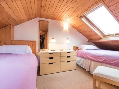 a attic bedroom with two beds and a skylight at 3 Bed in Applethwaite SZ540 in Applethwaite