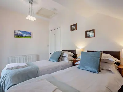 two beds in a room with white walls at 4 Bed in Keswick SZ292 in Keswick