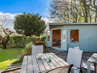 a table and chairs in a backyard with a shed at 4 Bed in Keswick SZ292 in Keswick