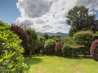 a garden with trees and shrubs and a field at 3 Bed in Applethwaite SZ328 in Applethwaite