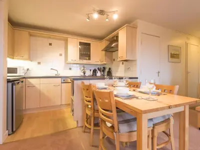 a kitchen with a wooden table and chairs in it at 3 Bed in Applethwaite SZ328 in Applethwaite