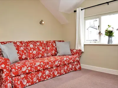 a red couch in a living room with a window at 5 Bed in Keswick oc-sz291 in Keswick