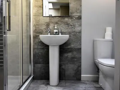 a bathroom with a sink and a shower and a toilet at 5 Bed in Keswick oc-sz291 in Keswick