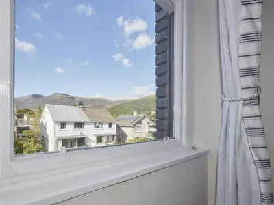 a window with a view of a house at 5 Bed in Keswick oc-sz291 in Keswick