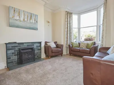 a living room with a fireplace and a couch and chairs at 5 Bed in Keswick oc-sz291 in Keswick