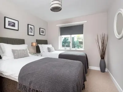 a bedroom with two beds and a window at 4 Bed in Keswick oc-sz219 in Grange
