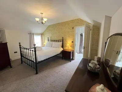 a bedroom with a large bed and a mirror at 2 Bed in Keswick SZ379 in Keswick