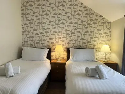 two beds sitting next to each other in a bedroom at 2 Bed in Keswick SZ379 in Keswick