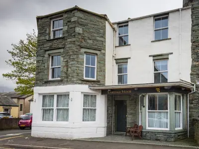 a stone house with a bench in front of it at 2 Bed in Keswick SZ379 in Keswick