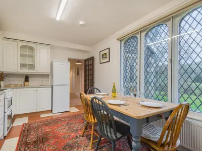 a kitchen with a table and chairs and a refrigerator at 2 Bed in Lorton SZ492 in Lorton