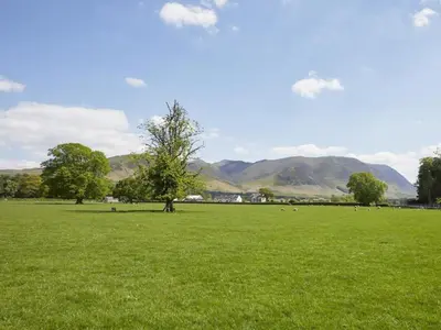 a field of green grass with mountains in the background at 2 Bed in Lorton SZ492 in Lorton