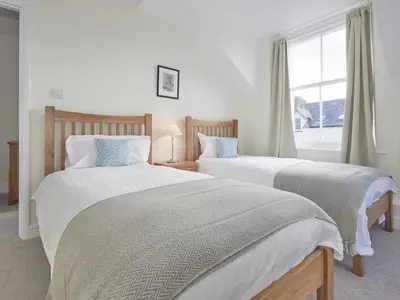 two beds in a bedroom with a window at 4 Bed in Keswick oc-sz443 in Keswick
