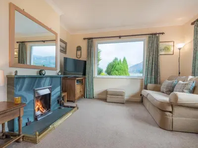 a living room with a fireplace and a couch at 3 Bed in Keswick oc-sz194 in Braithwaite