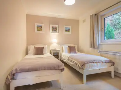 two beds in a bedroom with a window at 3 Bed in Keswick oc-sz194 in Braithwaite
