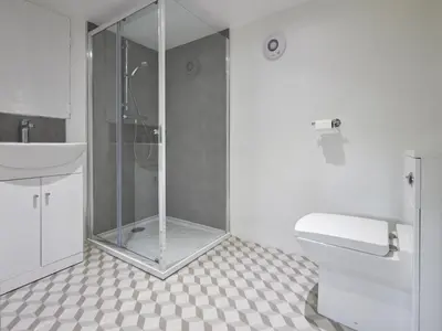 a bathroom with a shower and a toilet and a sink at 3 Bed in Keswick oc-sz194 in Braithwaite
