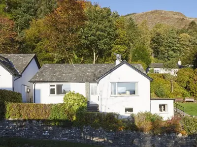 a white house with a fence in front of it at 3 Bed in Keswick oc-sz194 in Braithwaite