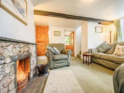 a living room with a stone fireplace at 2 Bed in Borrowdale SZ302 in Rosthwaite