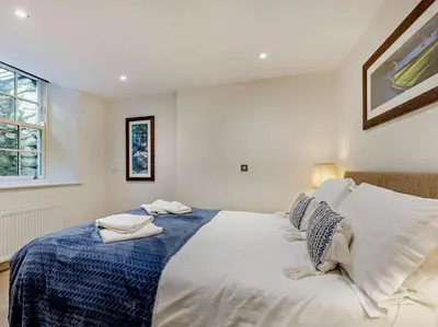 a bedroom with a large white bed with pillows at 2 Bed in Keswick oc-sz132 in Keswick