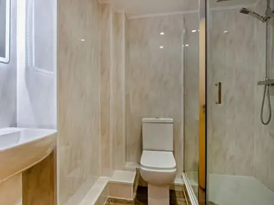 a bathroom with a toilet and a shower and a sink at 2 Bed in Keswick oc-sz132 in Keswick