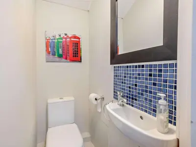 a bathroom with a toilet and a sink and a mirror at 3 Bed in Keswick oc-sz545 in Keswick