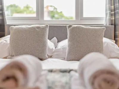 a bed with two pillows on top of it at 3 Bed in Keswick oc-sz545 in Keswick