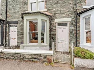 a brick building with a window and a gate at 3 Bed in Keswick oc-sz545 in Keswick