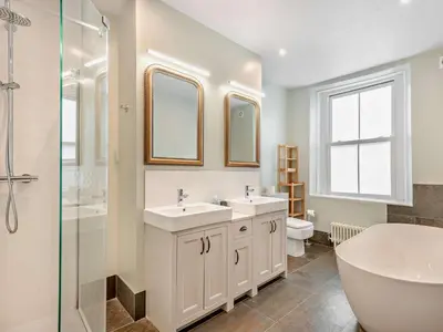 a bathroom with two sinks and a tub and a toilet at 3 Bed in Keswick oc-sz545 in Keswick