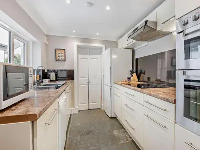 a kitchen with white cabinets and granite counter tops at 3 Bed in Keswick oc-sz545 in Keswick