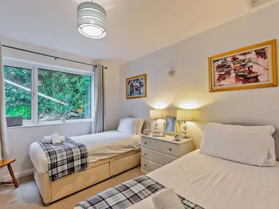 a bedroom with two beds and a window at 2 Bed in Wasdale oc-sz077 in Santon Bridge