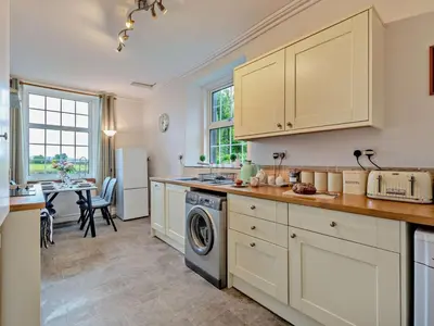 a kitchen with white cabinets and a dishwasher at 2 Bed in Wasdale oc-sz077 in Santon Bridge