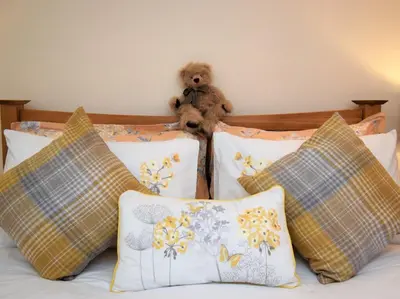 a teddy bear sitting on top of a bed with pillows at 2 Bed in Patterdale SZ470 in Patterdale