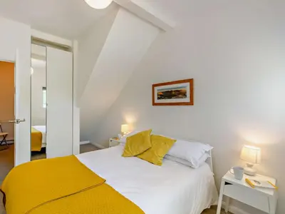 a bedroom with a white bed and a yellow blanket at 1 Bed in Lorton SZ160 in Lorton