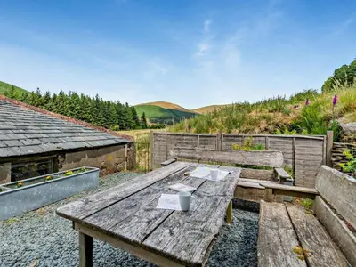 a wooden picnic table sitting on top of a hill at 1 Bed in Lorton SZ160 in Lorton