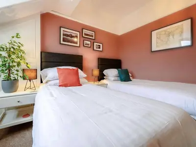 two beds in a room with orange walls at 3 Bed in Keswick oc-sz118 in Keswick
